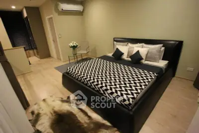 Modern bedroom with stylish decor and cozy ambiance in a luxury apartment.