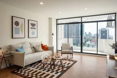 Modern living room with large windows and city view, featuring stylish decor and cozy seating area.