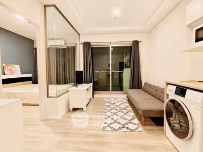 Modern apartment interior with open layout, featuring a cozy living area and a glimpse of the bedroom.