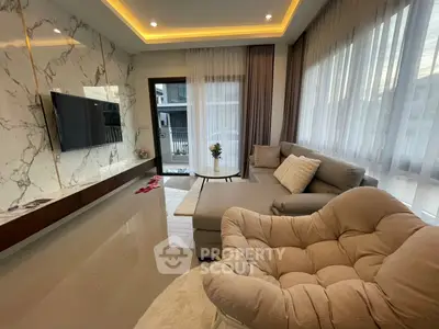 Luxurious modern living room with elegant marble wall and cozy seating area.