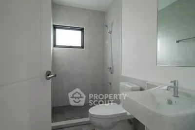 Modern minimalist bathroom with sleek fixtures and natural light