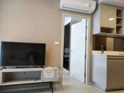 Modern living room with sleek TV unit and open kitchen layout