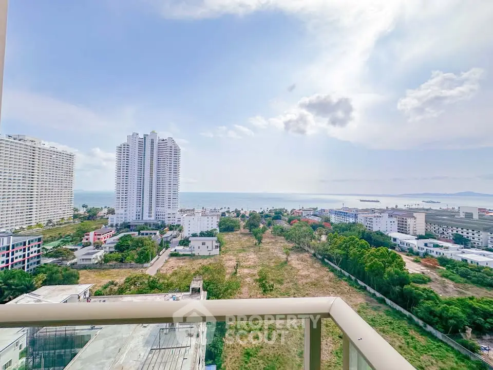 Stunning ocean view from high-rise balcony overlooking cityscape and greenery.