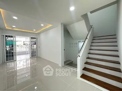 Modern interior with sleek staircase and glossy tiled flooring, perfect for contemporary living.