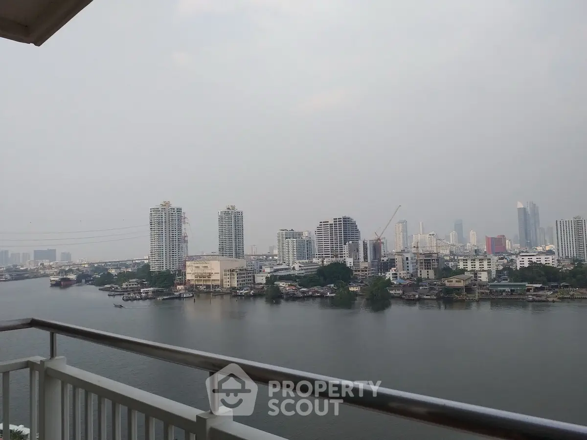 Stunning river view from a high-rise balcony overlooking city skyline, perfect for urban living enthusiasts.