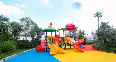 Vibrant playground with colorful slides in lush garden setting, perfect for family-friendly real estate.