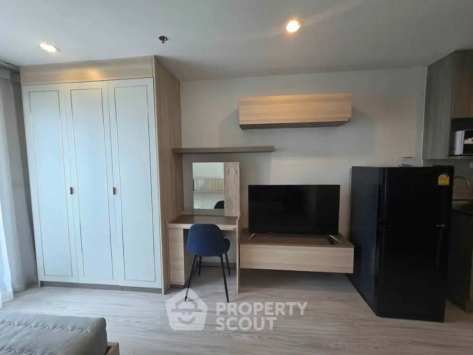 Modern living room with sleek furniture and built-in storage in a stylish apartment.