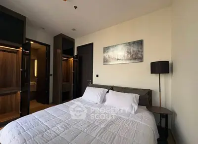 Modern bedroom with cozy bed and stylish decor in a contemporary apartment.