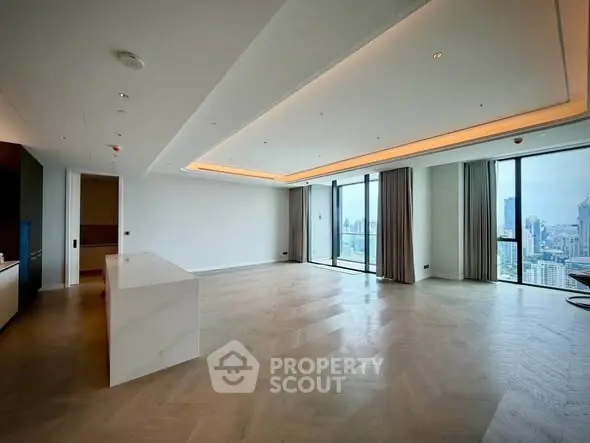 Spacious modern living room with panoramic city views and elegant lighting.