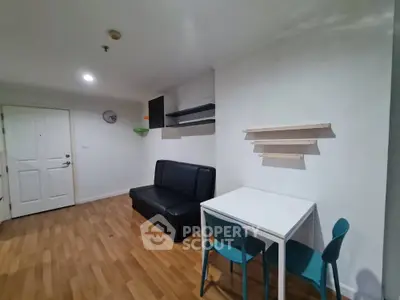 Cozy living room with modern furniture and wooden flooring in a stylish apartment.