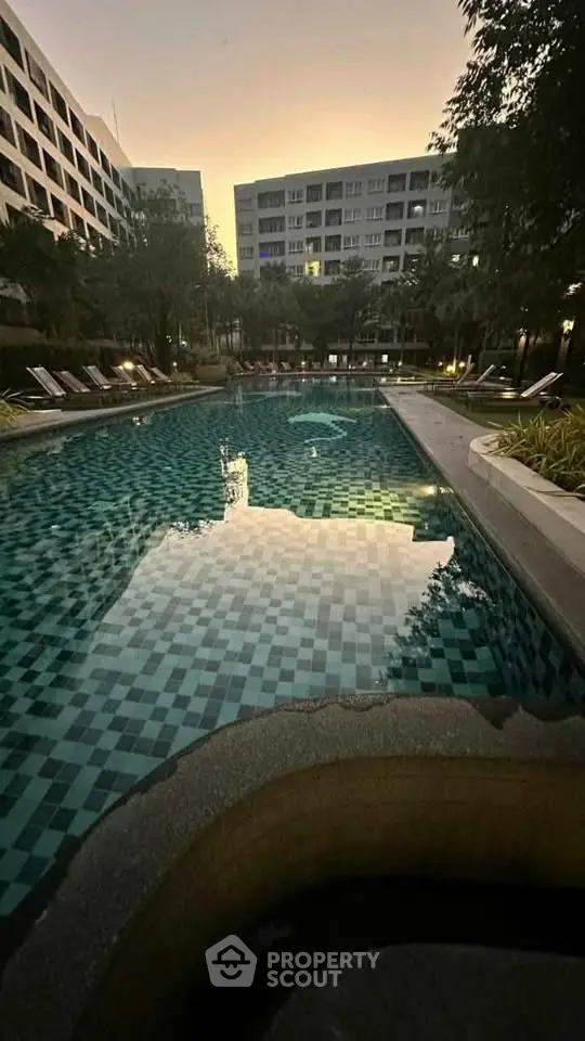 Luxurious residential pool area with serene ambiance and modern architecture at dusk.