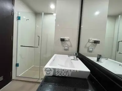 Modern bathroom with sleek glass shower and elegant sink design