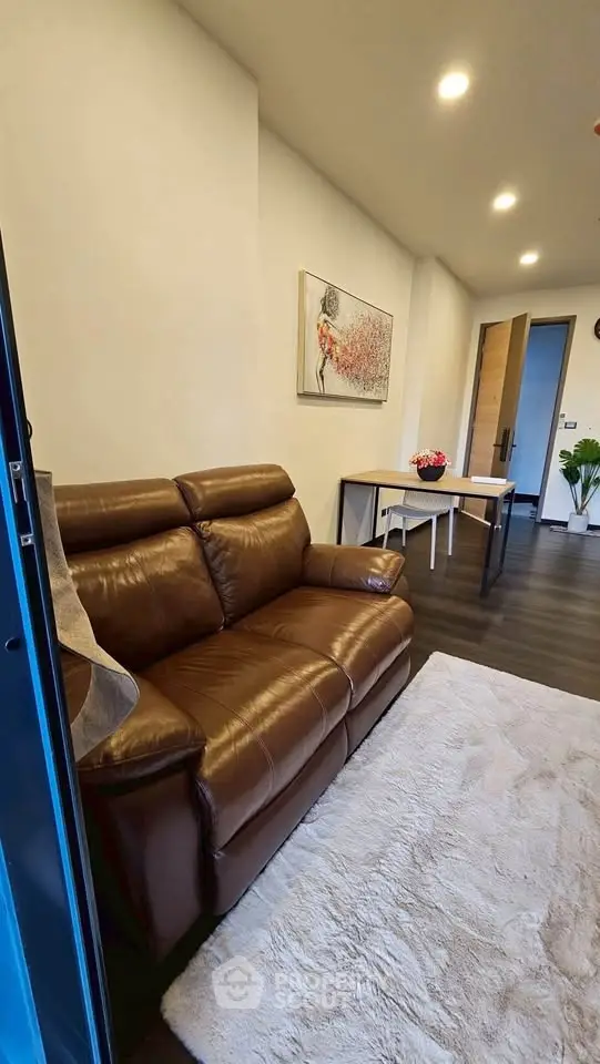 Modern living room with leather sofa and stylish decor in a cozy apartment.