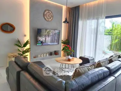 Luxurious living room with modern decor and large windows overlooking a lush garden.