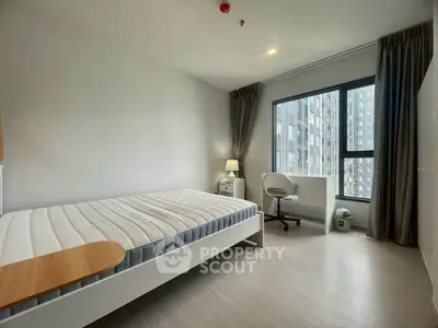 Modern bedroom with large window and city view, featuring a minimalist design and natural light.