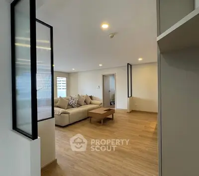 Spacious modern living room with cozy seating and stylish decor, perfect for relaxation and entertainment.