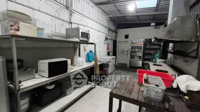 Spacious industrial-style kitchen with open shelving and modern appliances.