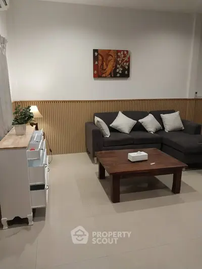 Spacious living room with modern decor and comfortable seating, perfect for relaxation and entertainment.