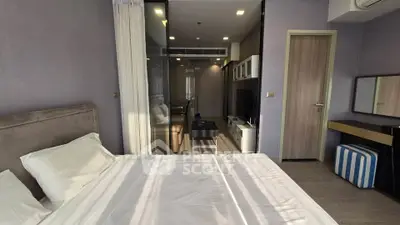 Modern bedroom with stylish decor and natural light in a contemporary apartment.