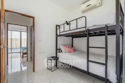 Modern bedroom with bunk beds and air conditioning, featuring sleek design and ample natural light.