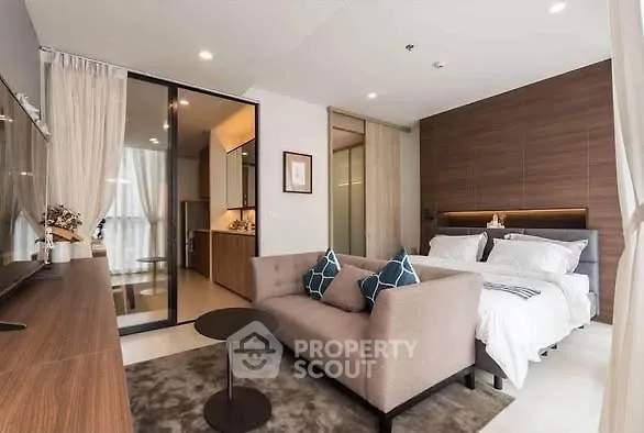 Modern studio apartment with cozy living area and stylish bedroom