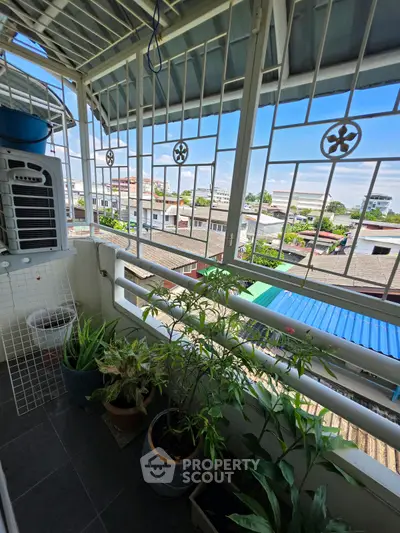 Charming balcony with lush plants and scenic neighborhood view, perfect for relaxation and enjoying fresh air.