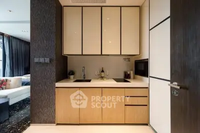 Modern kitchen with sleek cabinetry and integrated appliances in a stylish apartment.