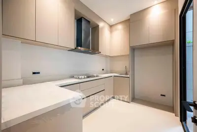 Modern kitchen with sleek cabinetry and gas stove in a contemporary home