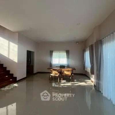 Spacious living room with elegant dining area and natural light