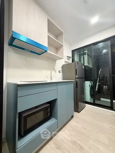 Modern kitchen with sleek appliances and open layout in stylish apartment