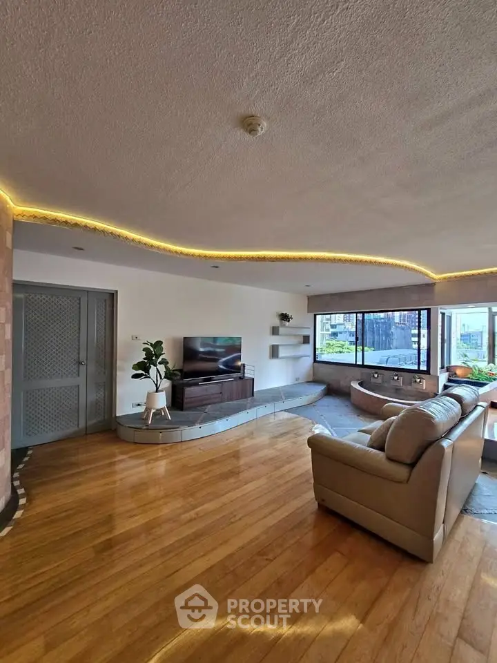 Spacious living room with modern decor and large windows offering natural light.