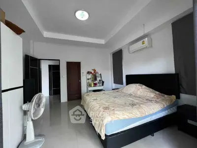 Spacious bedroom with modern furnishings and air conditioning, perfect for comfort and relaxation.