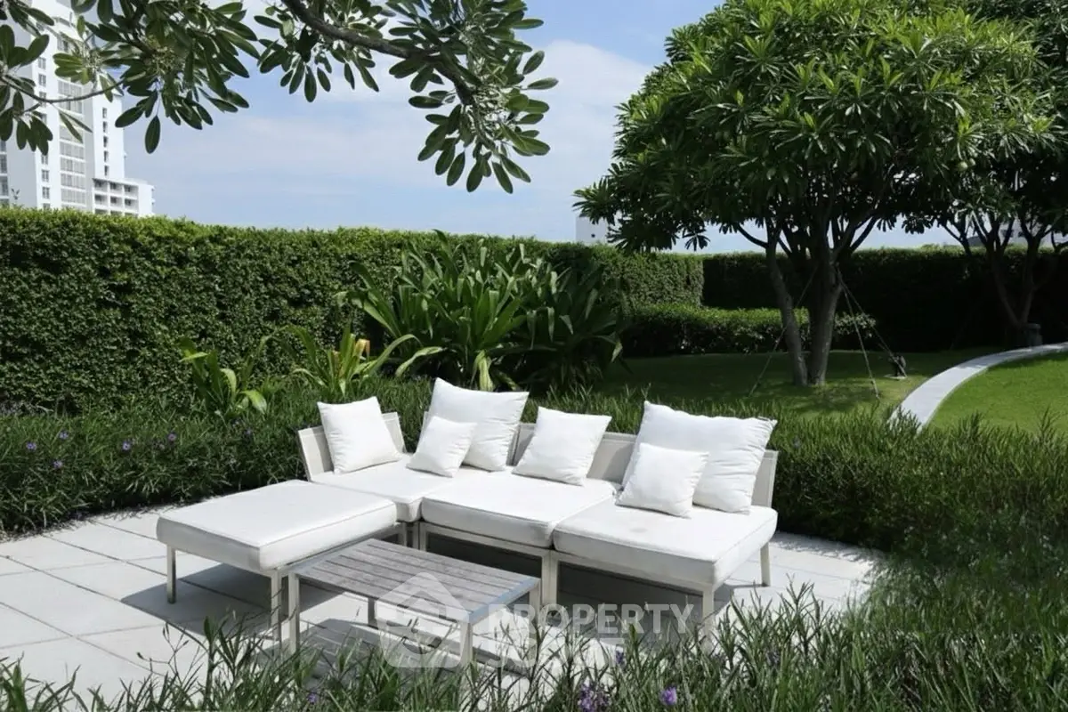 Luxurious garden with modern outdoor seating and lush greenery, perfect for relaxation and entertaining.