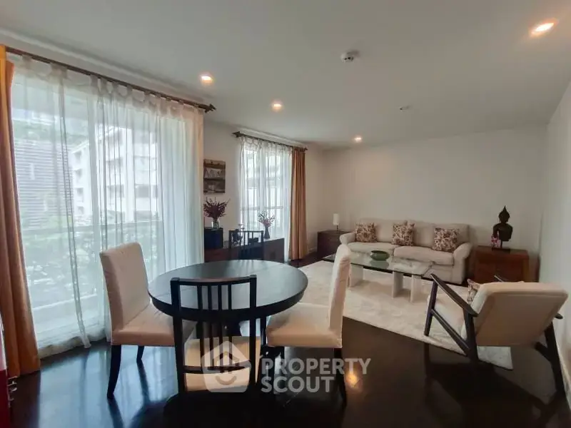 Spacious living room with elegant decor and large windows in modern apartment