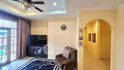 Spacious living room with modern decor and large window for natural light.
