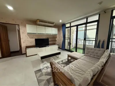 Spacious living room with modern decor and large windows for natural light