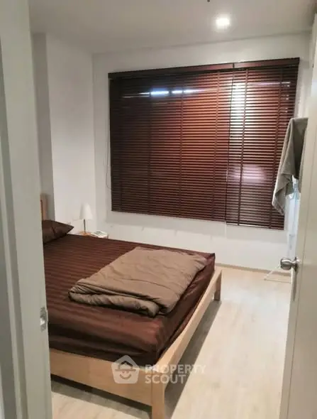 Cozy bedroom with wooden blinds and modern decor