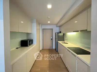 Modern kitchen with sleek cabinetry and built-in appliances in a contemporary apartment.