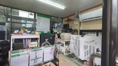 Compact office space with modern equipment and air conditioning, ideal for efficient work environment.