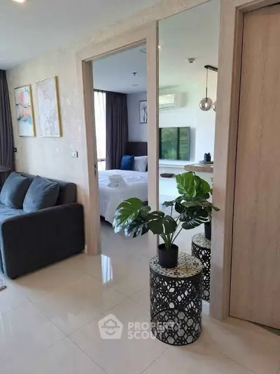 Modern apartment interior with stylish living room and cozy bedroom, featuring elegant decor and natural light.
