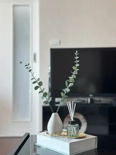 Modern living room with stylish decor and large TV, perfect for relaxation and entertainment.
