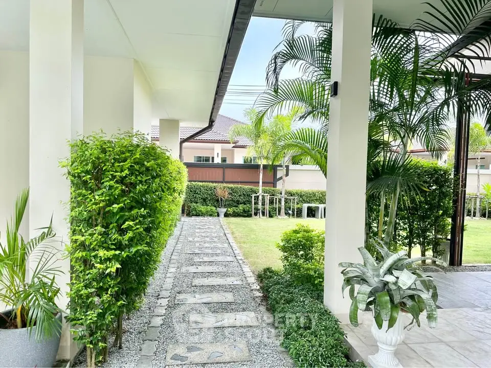 Charming garden pathway with lush greenery and modern architecture