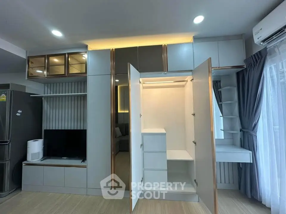 Modern living room with built-in storage and sleek design in a contemporary apartment.