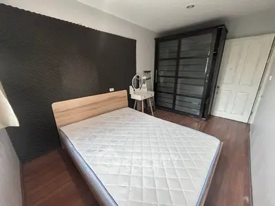 Cozy bedroom with wooden flooring and modern wardrobe