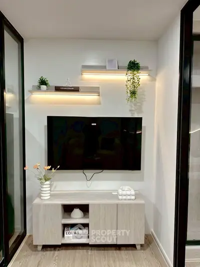 Modern living room with sleek TV setup and stylish shelving