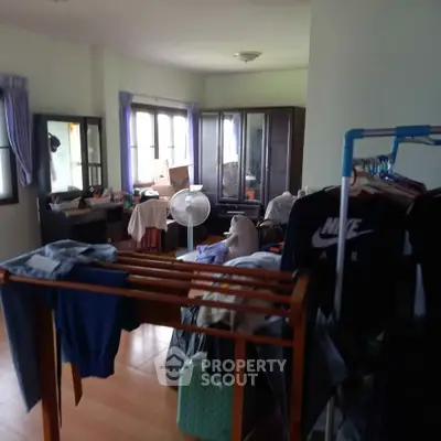 Spacious bedroom with ample natural light and storage solutions, ideal for comfortable living.