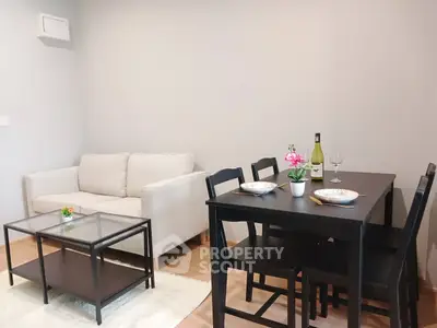 Cozy living room with dining area, featuring modern furniture and elegant decor.
