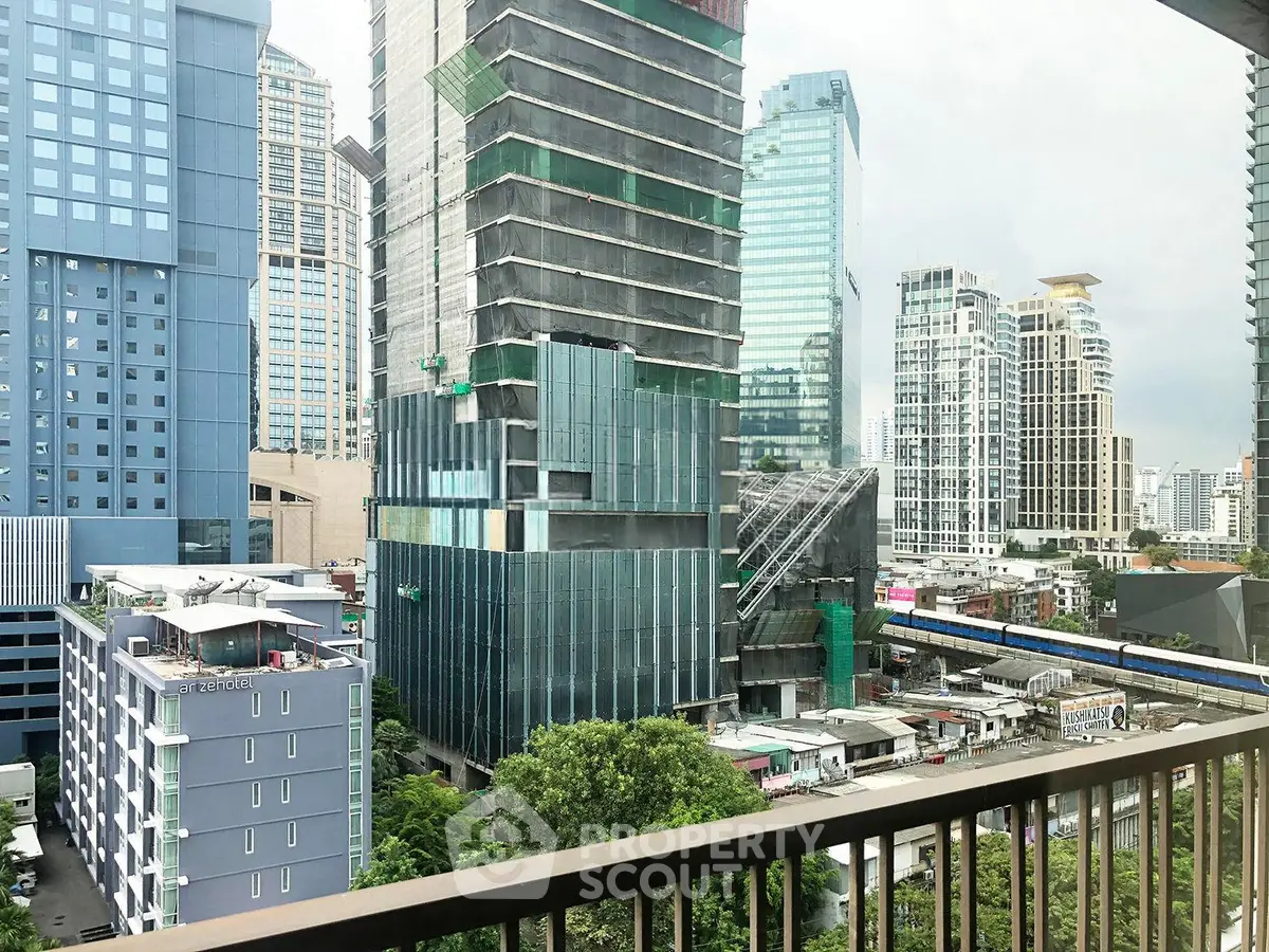 Stunning urban view from a high-rise balcony overlooking modern skyscrapers and cityscape.