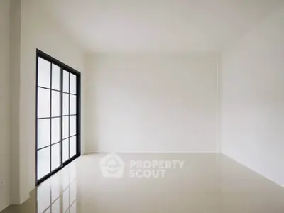 Spacious empty room with large windows and glossy tiled floor, perfect for customization.
