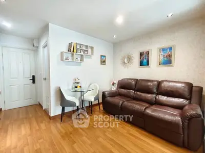 Charming living room with cozy leather sofa and elegant dining area, perfect for relaxation and entertaining.